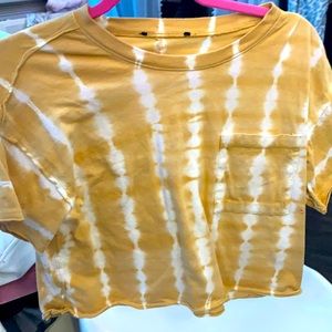 Yellow shirt with white squiggle design. Size: 12 yr.